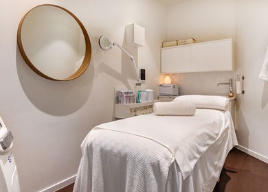 Luxurious spa treatment room at Doncaster East, Victoria, AU featuring a treatment bed and elegant decor.