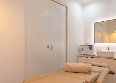 Tranquil treatment room at Soraya Skin Clinic Prahran, Victoria, AU featuring a cushioned table and modern decor.