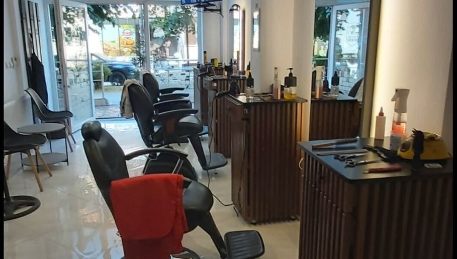 Sleek interior of Barber Shop Labi in Prishtina, XK, showcasing modern chairs and styling stations.