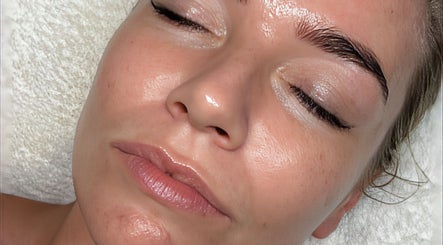 Relaxed woman enjoying facial treatment at Kelly Winstanley Beauty, Liverpool, England, GB.