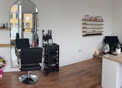 Elegant interior of EmHanced Nails, Shipley, England, GB featuring modern salon setup and nail polish display.