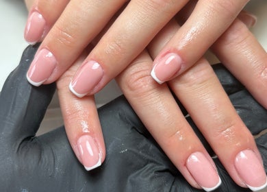 Elegant French manicure at EmHanced Nails, Shipley, England, GB. Perfectly polished pink nails with white tips.