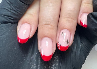 Elegant red-tipped manicure at EmHanced Nails, Shipley, England, GB. Perfect for a chic, modern look.
