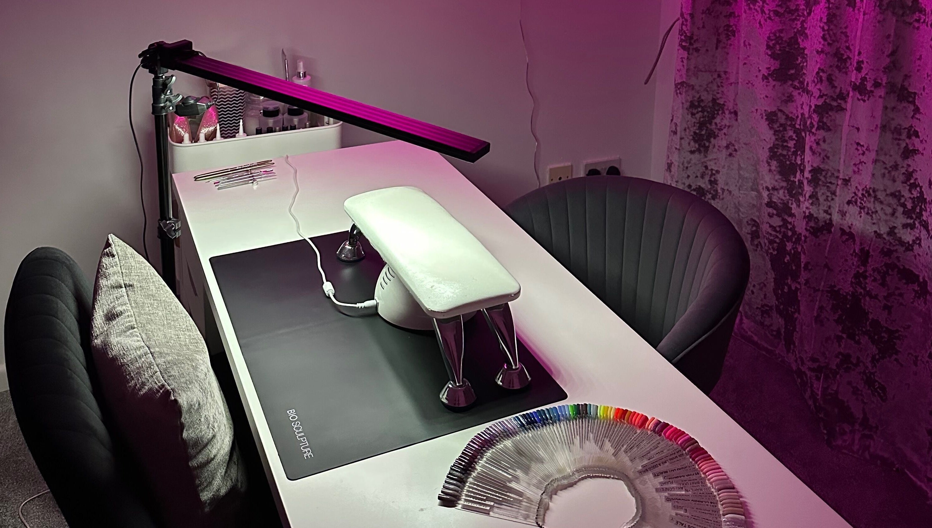 Nail setup at Njoynails, Stanbridge, England, GB with colorful nail samples and sleek decor.
