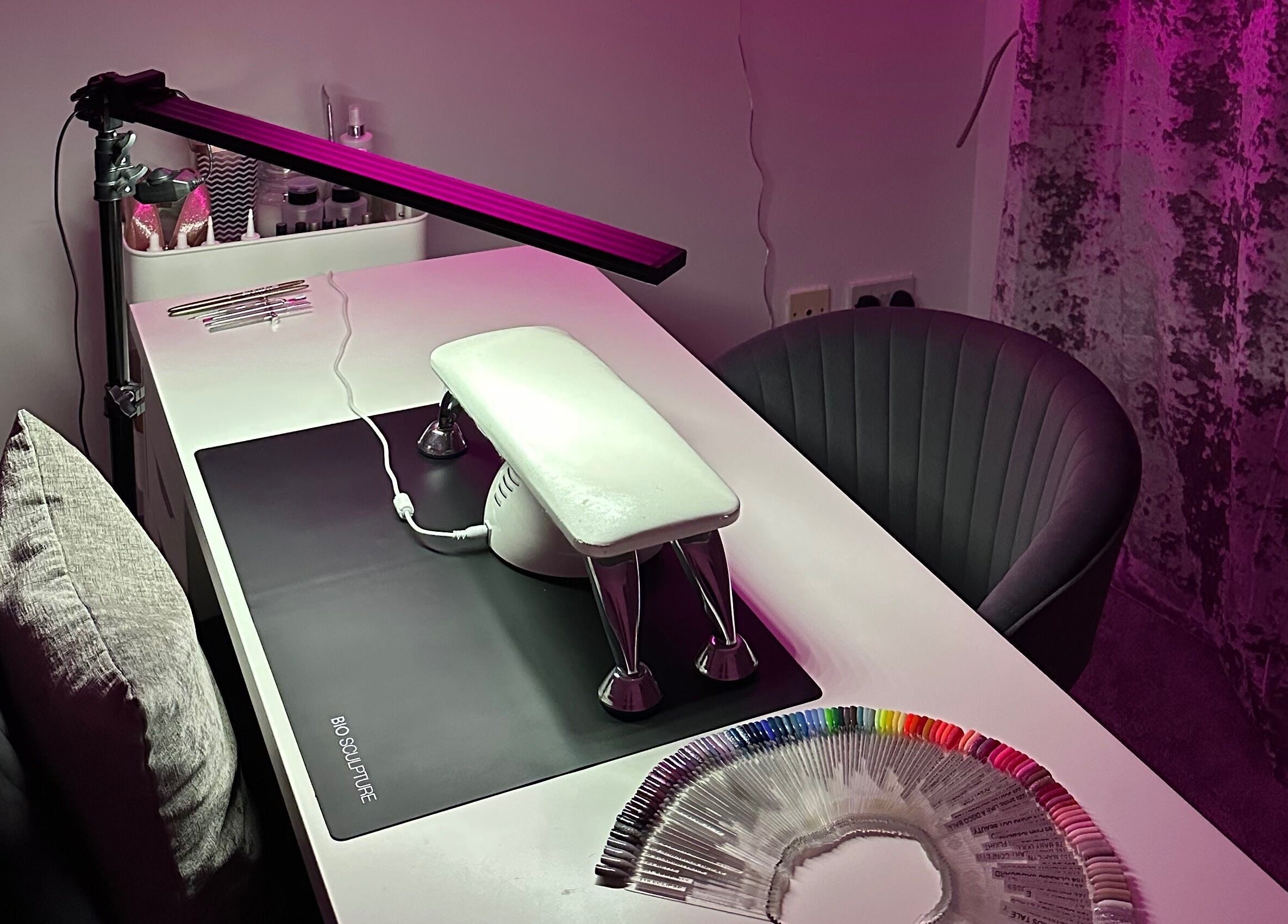 Nail setup at Njoynails, Stanbridge, England, GB with colorful nail samples and sleek decor.