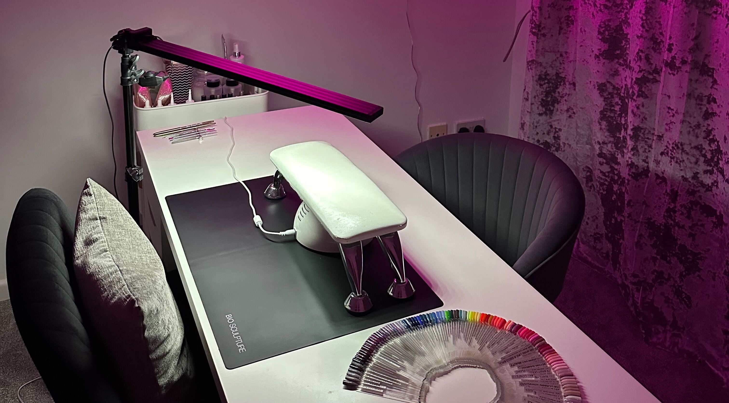 Nail setup at Njoynails, Stanbridge, England, GB with colorful nail samples and sleek decor.