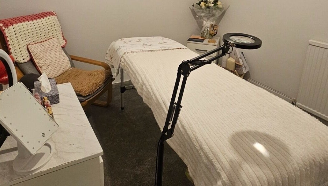 Relaxing treatment room at Blushed by Olga, Hatfield, England, GB, showcasing a comfortable bed and calming decor.