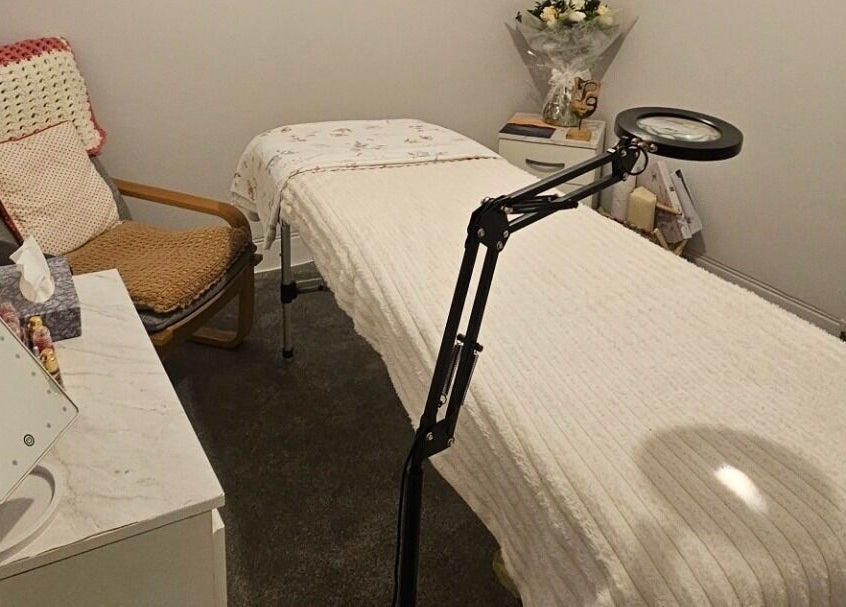 Relaxing treatment room at Blushed by Olga, Hatfield, England, GB, showcasing a comfortable bed and calming decor.