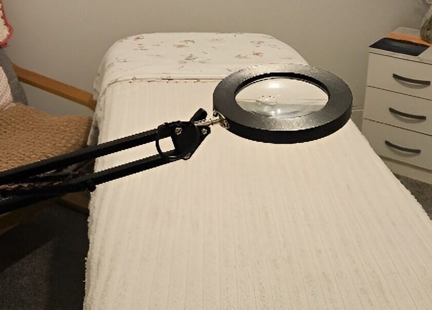 Treatment room at Blushed by Olga, Hatfield, England, GB, showcasing a cozy massage bed with a lamp.