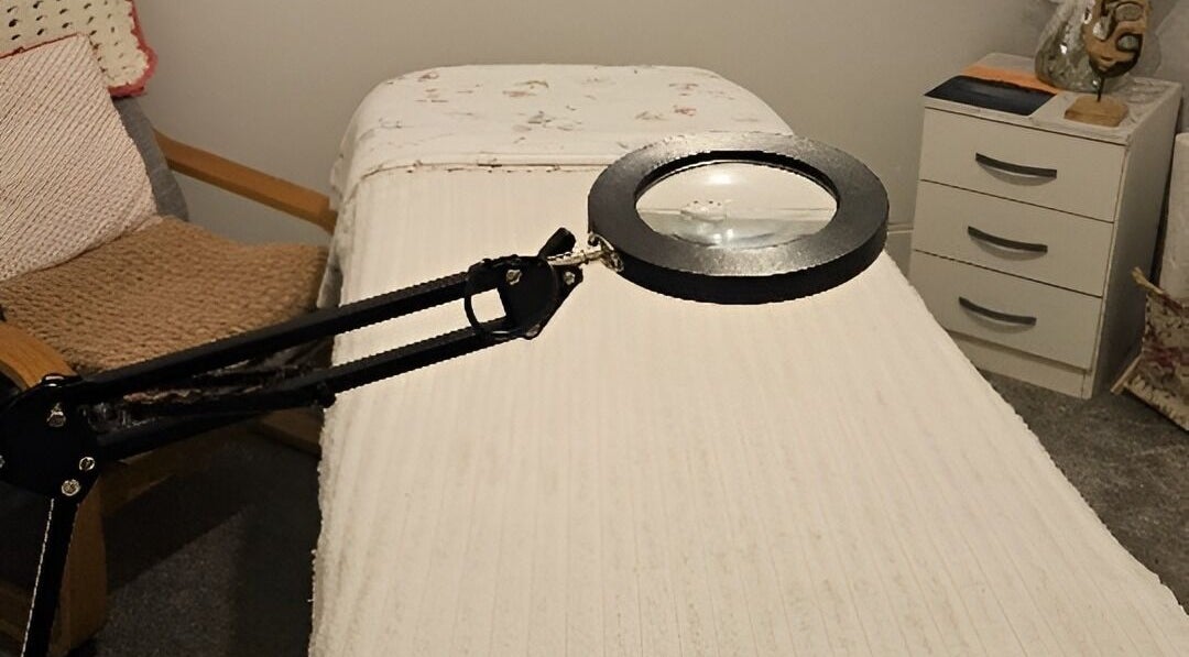 Treatment room at Blushed by Olga, Hatfield, England, GB, showcasing a cozy massage bed with a lamp.