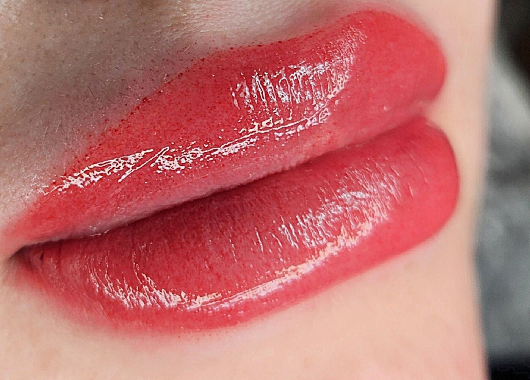 Close-up of glossy red lips enhanced at Blushed by Olga, Hatfield, England, GB.