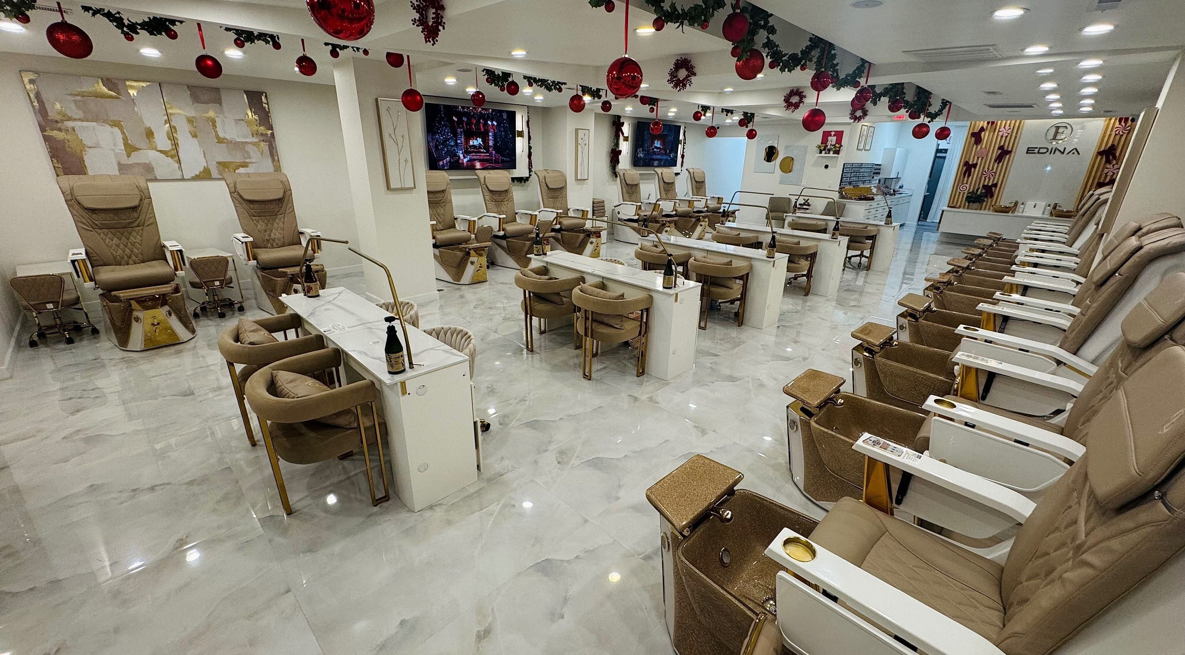 Elegant interior of Edina Nails Spa, Delaware, Ohio, showcasing plush pedicure chairs and festive decor.
