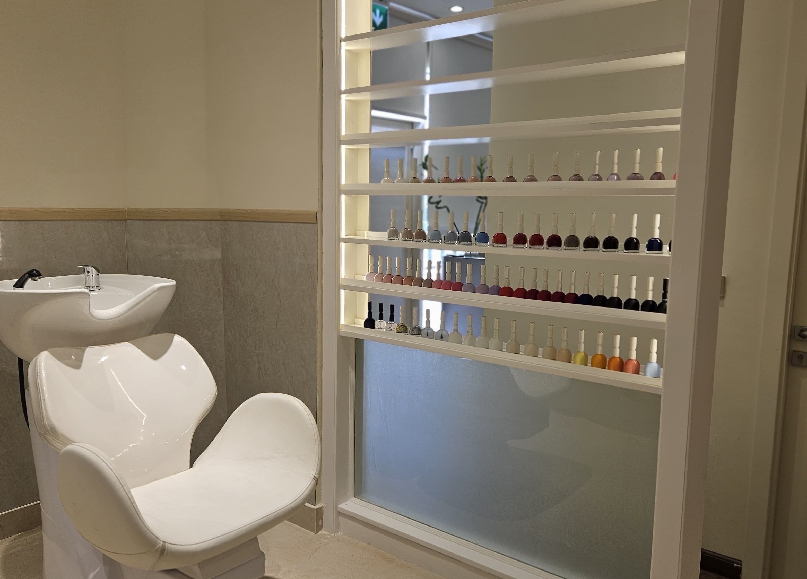 Sleek wash station and nail polish display at Cattleya Beauty Salon in Dubai, AE.