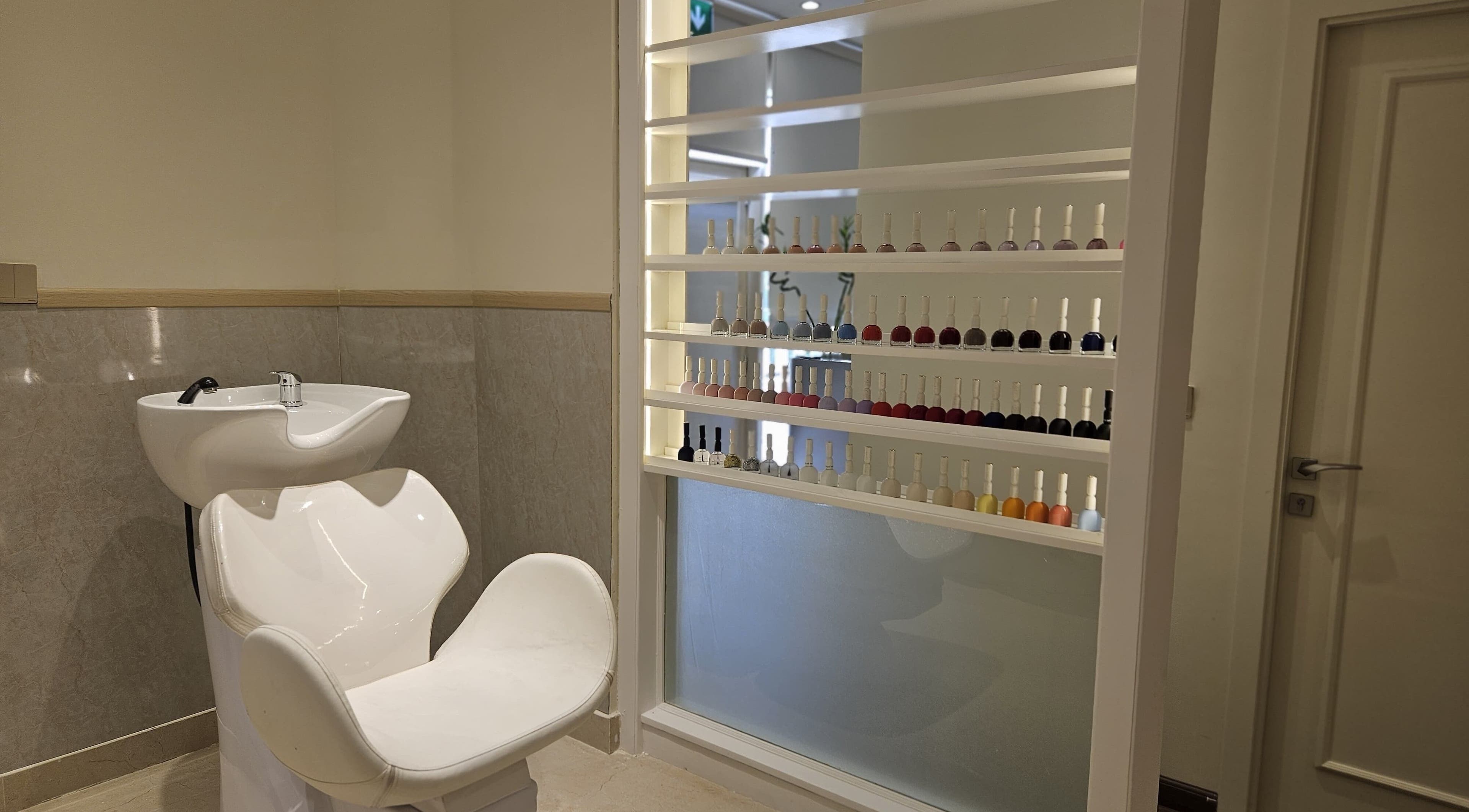 Sleek wash station and nail polish display at Cattleya Beauty Salon in Dubai, AE.
