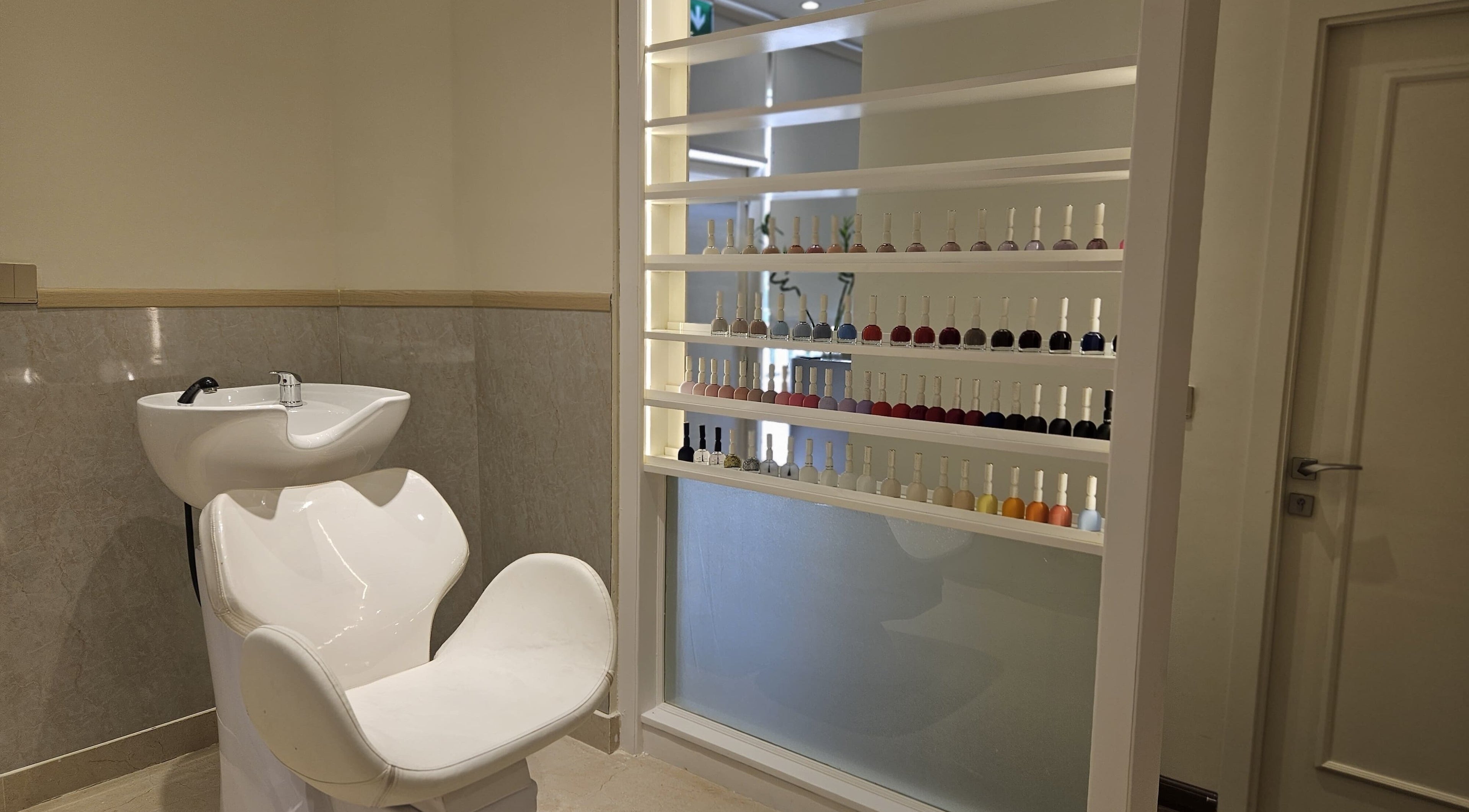 Sleek wash station and nail polish display at Cattleya Beauty Salon in Dubai, AE.