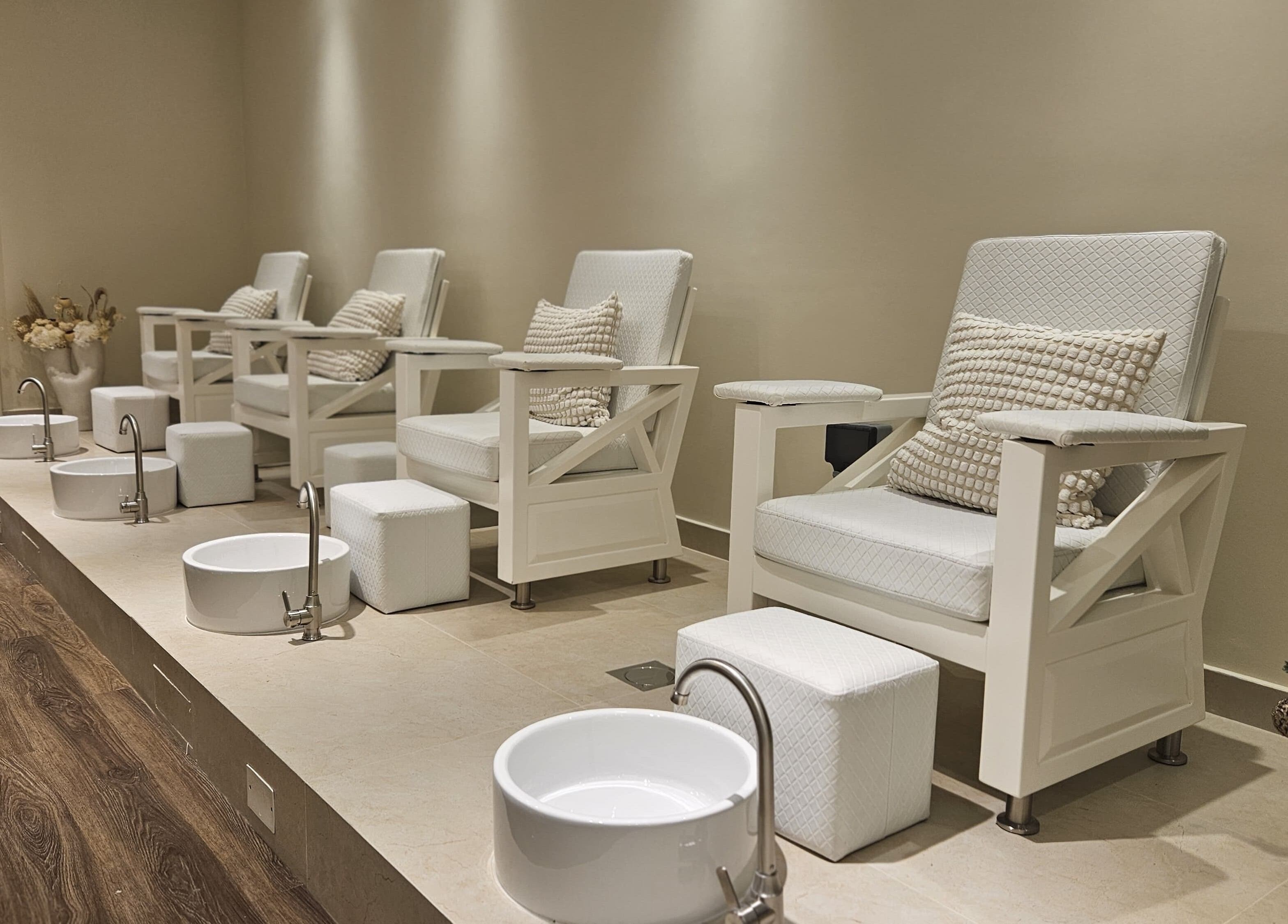 Elegant pedicure chairs at Cattleya Beauty Salon, Dubai, AE offering a relaxing foot spa experience.