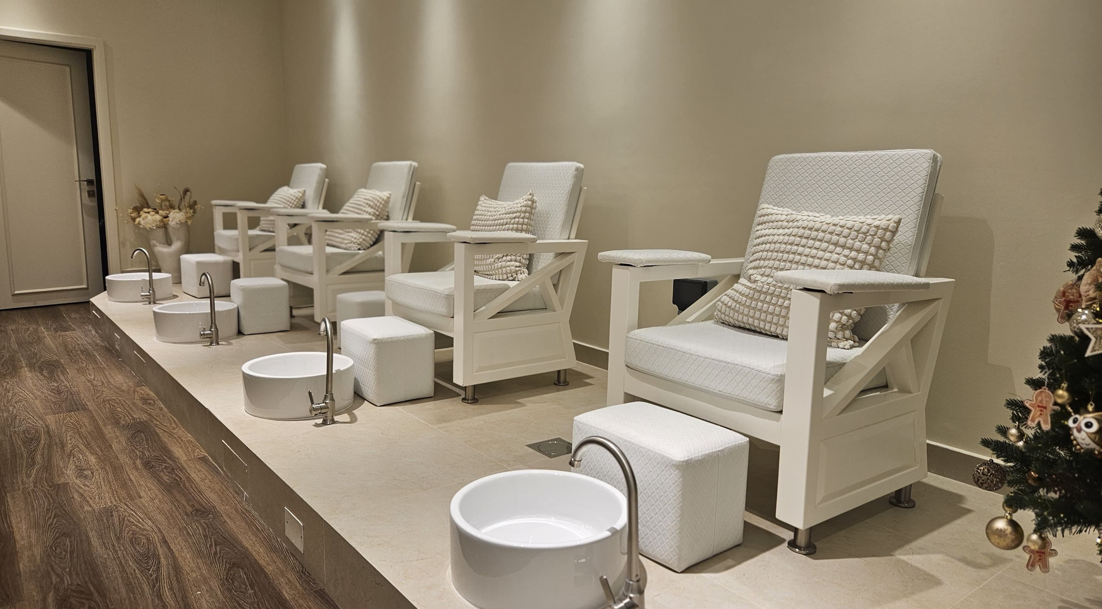 Elegant pedicure chairs at Cattleya Beauty Salon, Dubai, AE offering a relaxing foot spa experience.