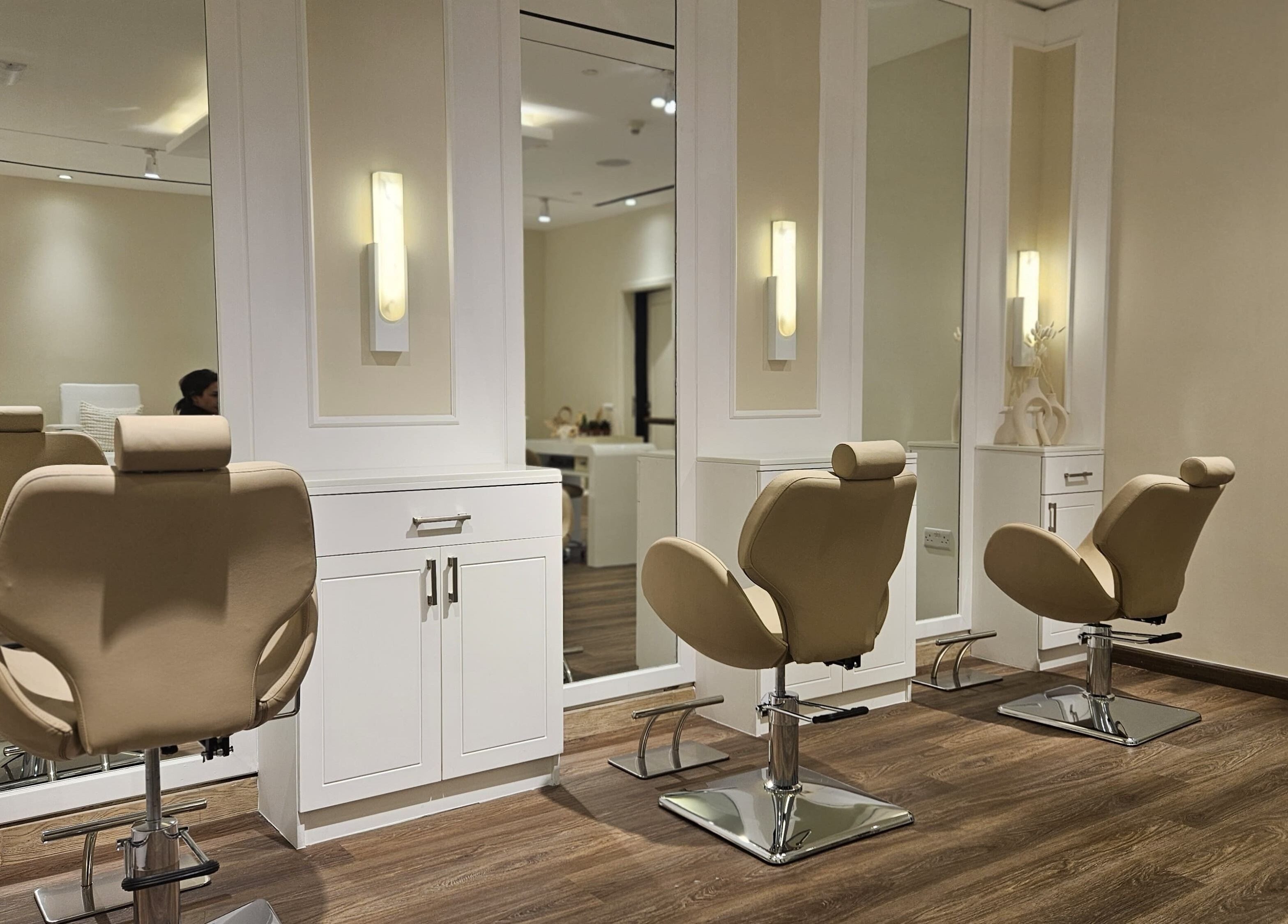 Elegant styling chairs in Cattleya Beauty Salon, Dubai, AE, offering a serene and luxurious atmosphere.