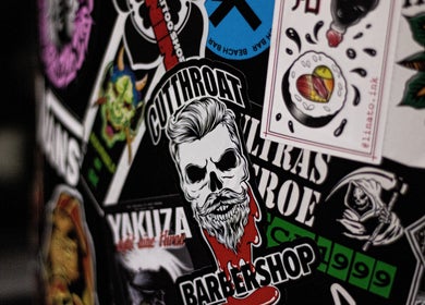 Stickers at Cutthroat, Stara Zagora, BG showcase a bold barber design with artistic flair.