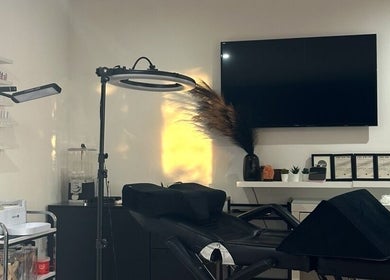 Chic treatment area at Geeleigh Beauty Bar, Reading, England with modern decor and equipment.