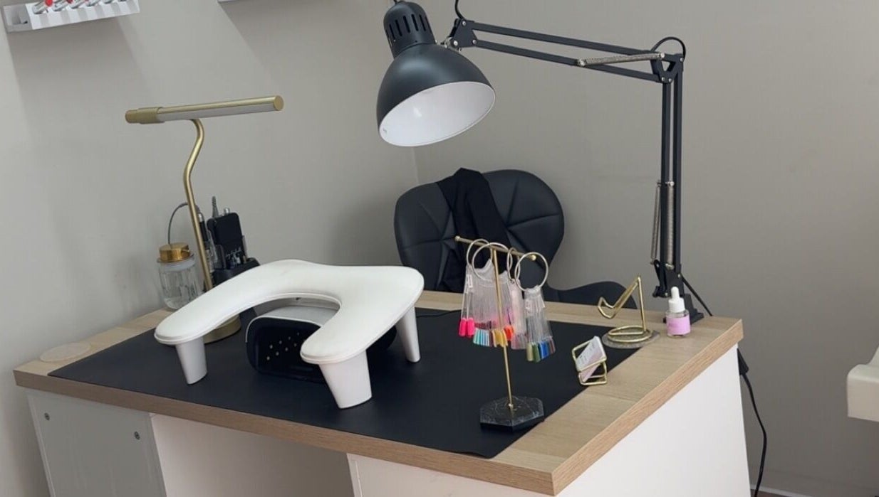 Modern nail station at Nails by Court, Cardiff, Wales, GB featuring a sleek work desk and lighting.