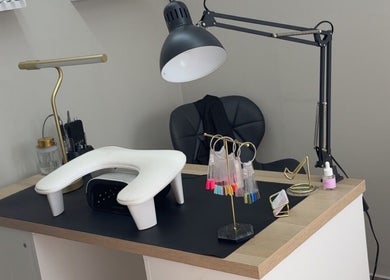 Modern nail station at Nails by Court, Cardiff, Wales, GB featuring a sleek work desk and lighting.