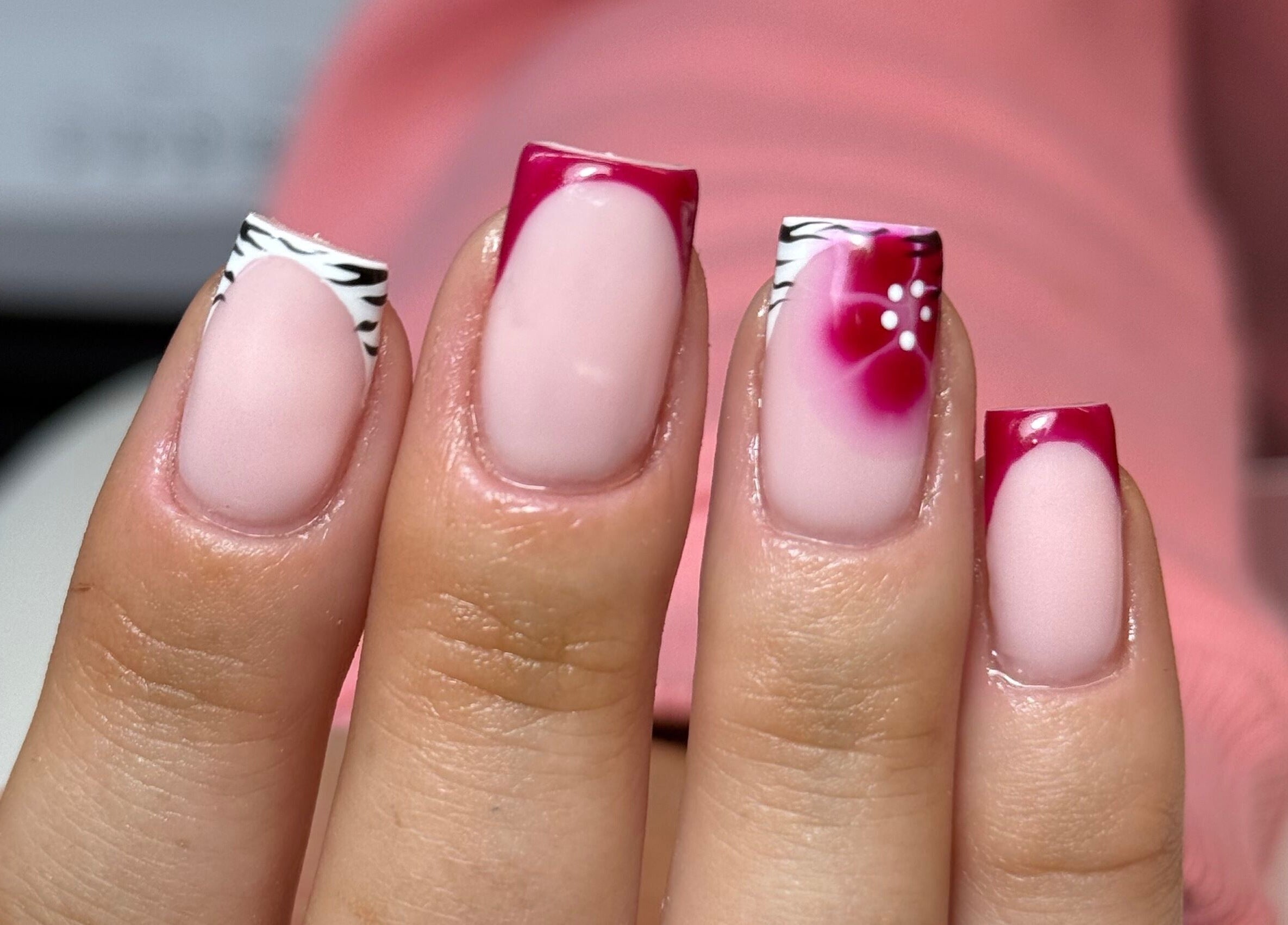 Stylish nail art with pink and zebra design at Nails by Court, Cardiff, Wales, GB.