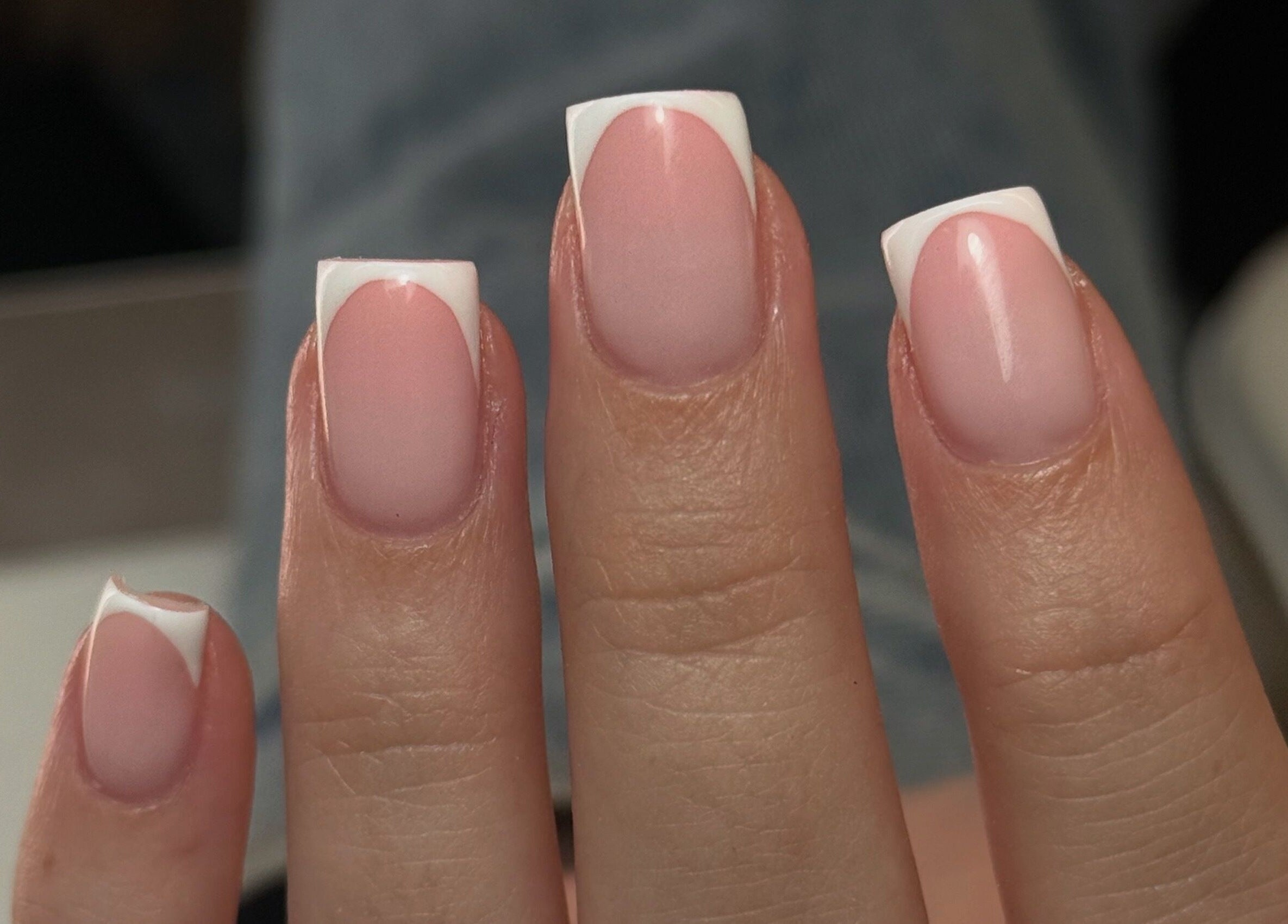 Elegant French manicure from Nails by Court in Cardiff, Wales, GB showcasing stylish pink and white nail art.