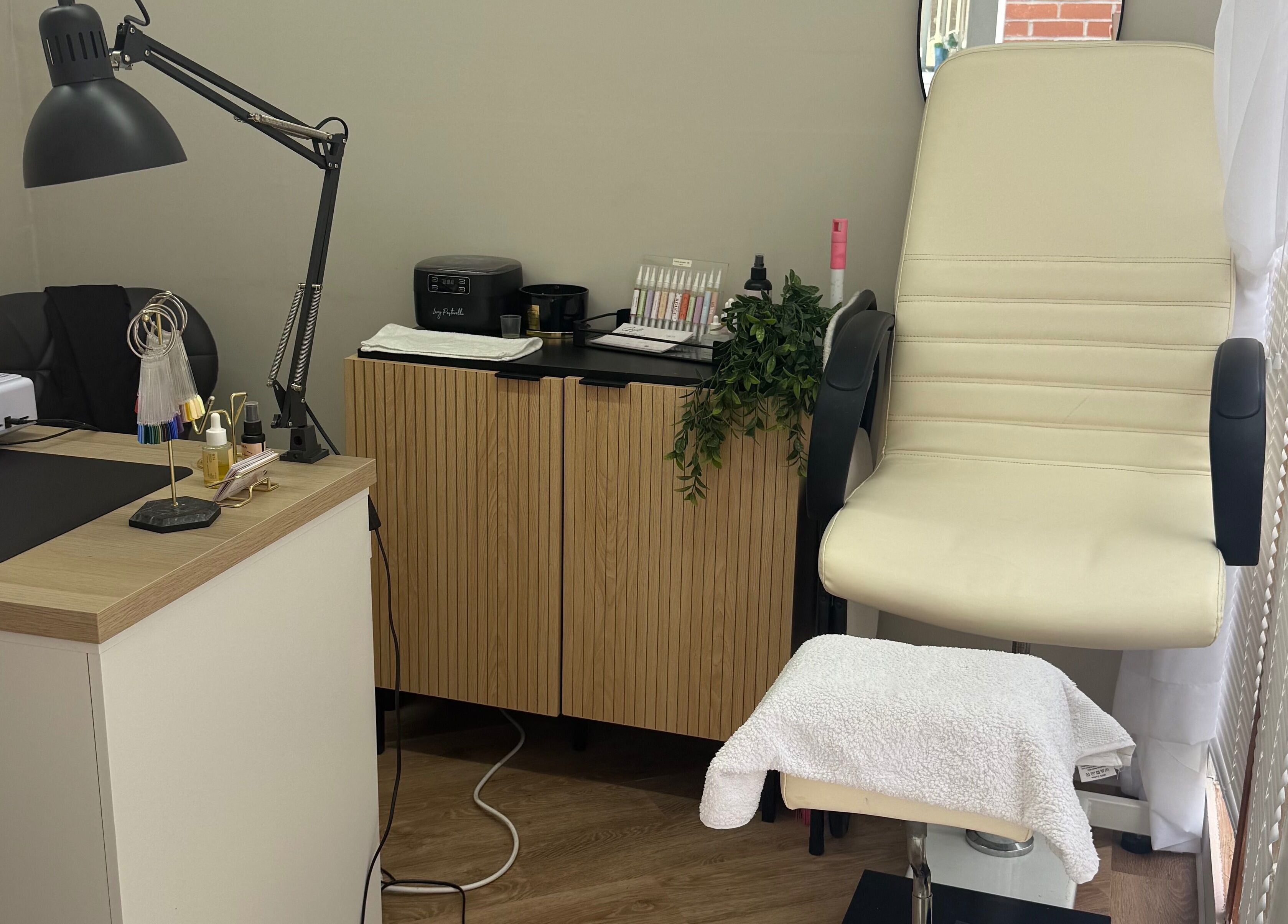 Beauty by Court's cozy treatment space in Cardiff, Wales, GB featuring a massage chair and modern decor.