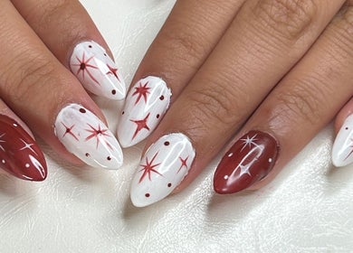 Red and white star-themed nail art at Klawed by Karissa, Vancouver, British Columbia, CA.