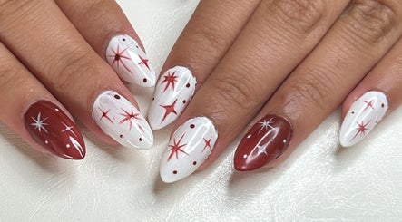 Red and white star-themed nail art at Klawed by Karissa, Vancouver, British Columbia, CA.