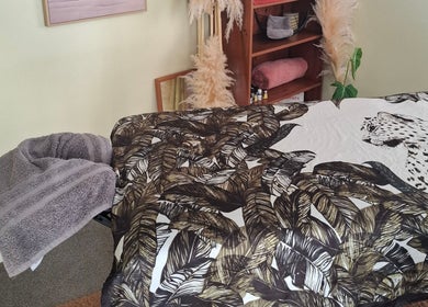 Elegant massage room at Annaste, Nelson, NZ with chic decor and fluffy towels.