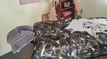 Elegant massage room at Annaste, Nelson, NZ with chic decor and fluffy towels.