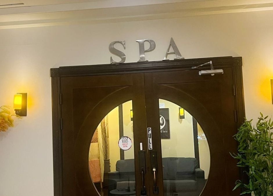 Elegant wooden doors at Beng Teng Spa, Tumon, GU welcoming guests to a serene experience.