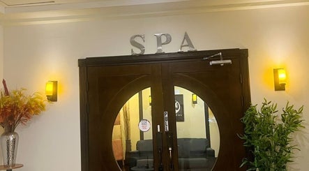 Elegant wooden doors at Beng Teng Spa, Tumon, GU welcoming guests to a serene experience.