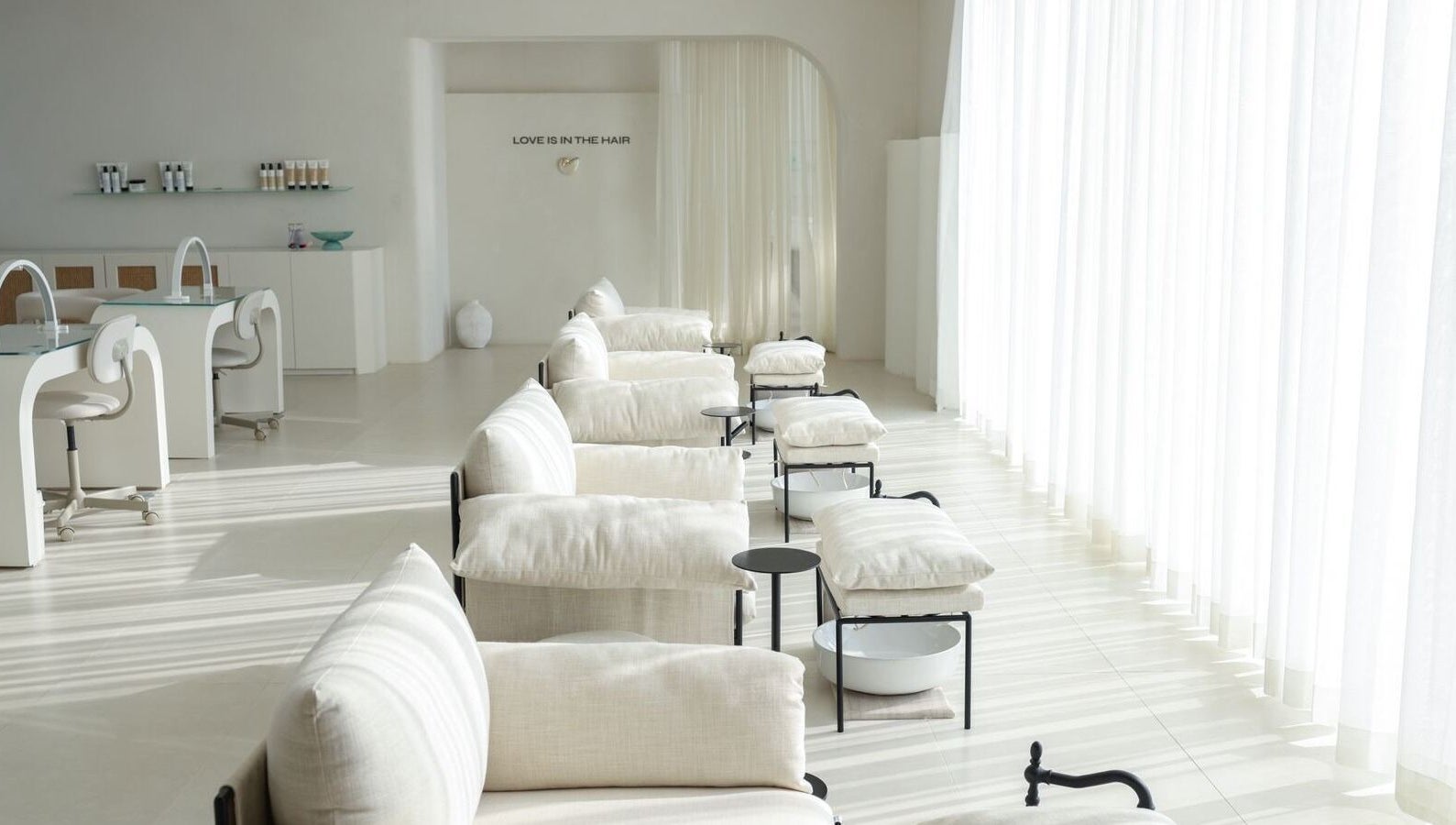 Elegant interior of MYB Lounge & Spa, Al Khobar, Eastern Province, SA with sunlight and white decor.