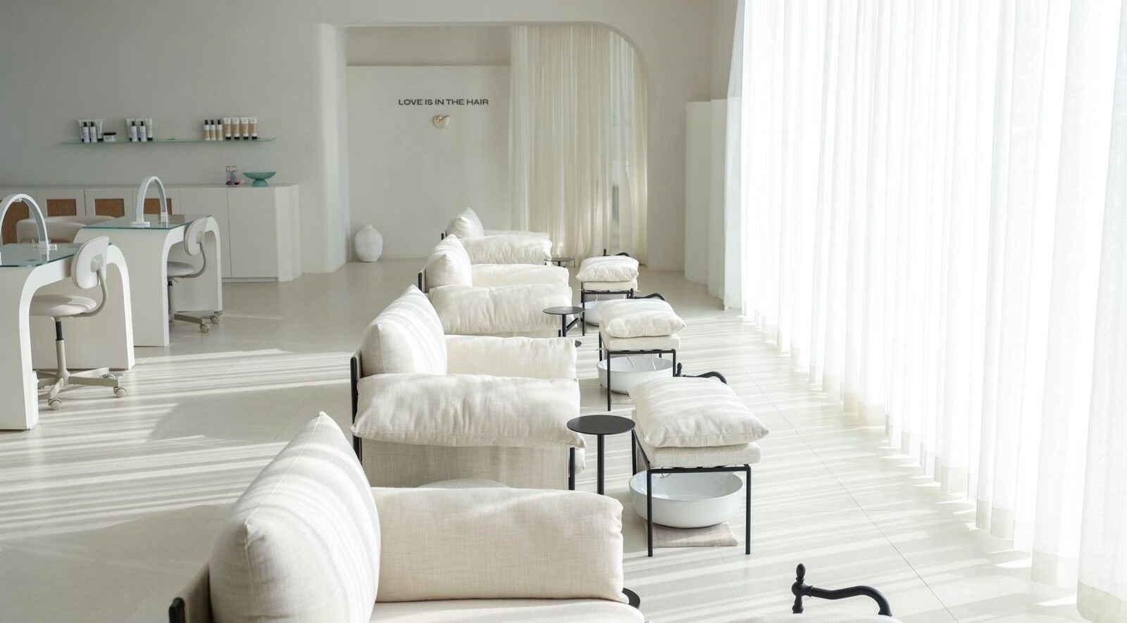 Elegant interior of MYB Lounge & Spa, Al Khobar, Eastern Province, SA with sunlight and white decor.