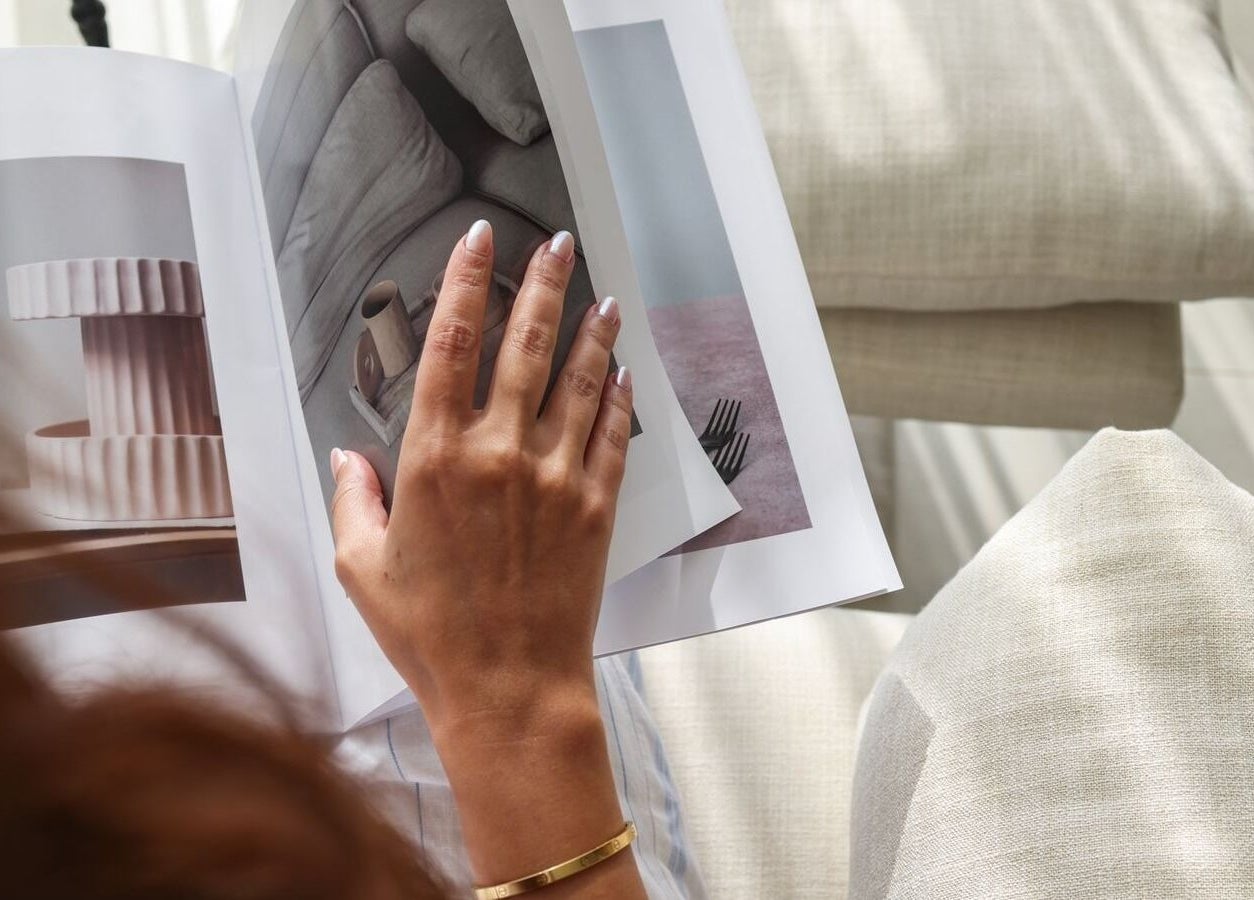 Hand browsing magazine at MYB Lounge & Spa, Al Khobar, Eastern Province, SA. Elegant decor inspiration.