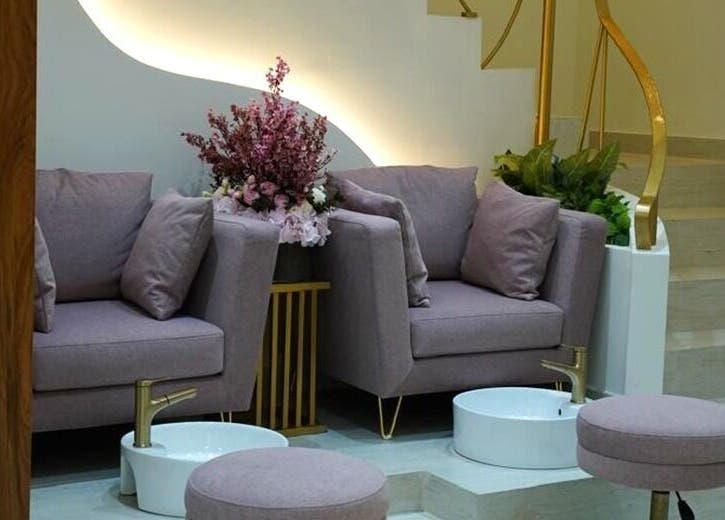 Elegant pedicure area at Beauty Experience Ladies Salon, Sharjah, Sharjah, AE with plush chairs and floral accents.