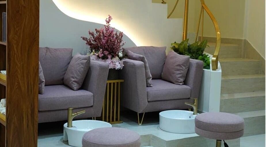 Elegant pedicure area at Beauty Experience Ladies Salon, Sharjah, Sharjah, AE with plush chairs and floral accents.