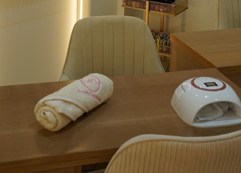 Manicure station at Beauty Experience Ladies Salon in Sharjah, Sharjah, AE, featuring plush chairs and equipment.