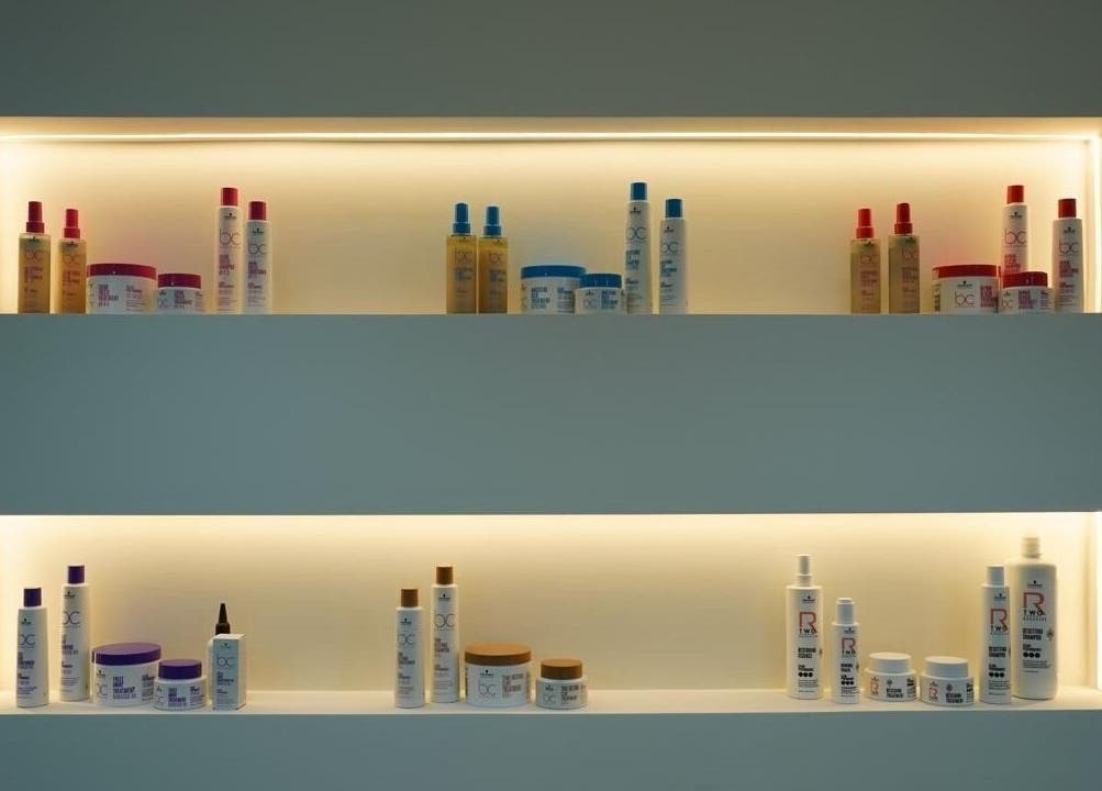 Beauty Experience Ladies Salon in Sharjah, Sharjah, AE displays products on illuminated shelves.