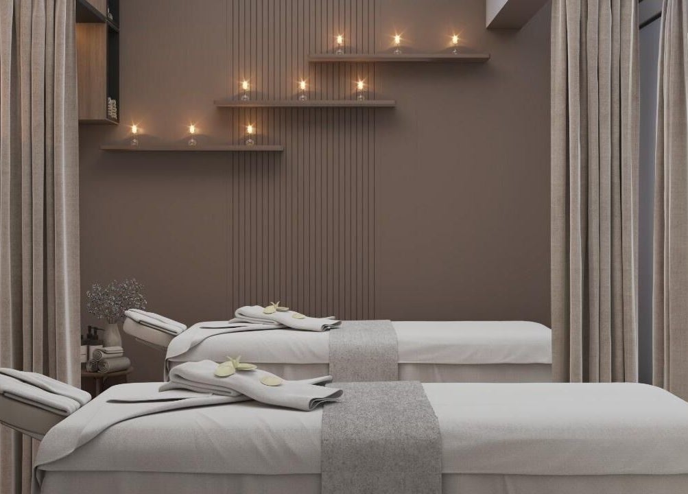 Luxurious spa room at Team Salon, الرياض, Riyadh Province, SA with massage tables and candles.