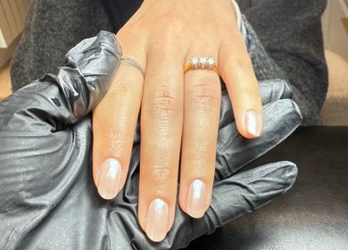 Elegant nail art service at ML BEAU-TY in Waterlooville, England, GB. Hand with polished nails and diamond ring.