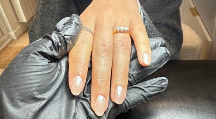 Elegant nail art service at ML BEAU-TY in Waterlooville, England, GB. Hand with polished nails and diamond ring.