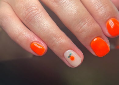 Bright orange gel nails with a cute fruit design at ML BEAU-TY, Waterlooville, England, GB.