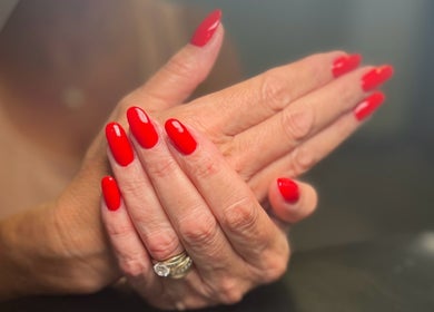 Vibrant red nails freshly manicured at ML BEAU-TY, Waterlooville, England, GB.