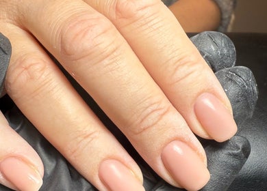 Elegant nude manicure at ML BEAU-TY in Waterlooville, England, GB. Perfectly shaped nails on display.