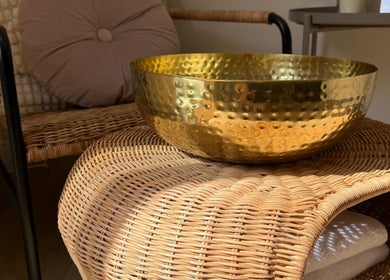 Relaxing decor with a golden bowl and wicker chair at ML BEAU-TY in Waterlooville, England, GB.