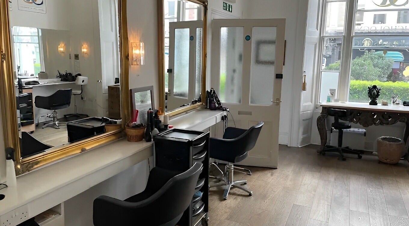 Modern interior of Fresh Men’s Hairdressers in London, England, GB, featuring elegant styling stations and decor.